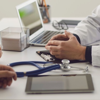 a doctor who's face is out of the frame consulting with a patient used on a page about MGI being specialist accountants for doctors